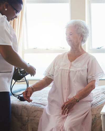 Nursing Care nurse with elderly patient
