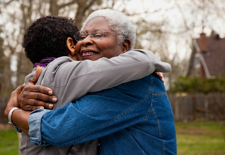 caregiver hugging patient
